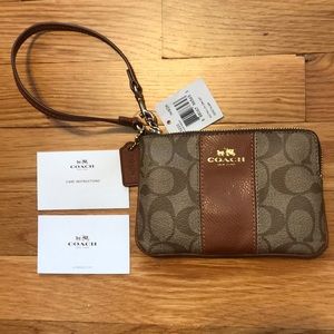 Coach Signature PVC wristlet leather brown.